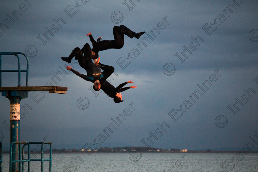 Blackrock Diving Boards-2 
 Three friends backflip off the Blackrock diving board in Salthill, Galway. Picture: Conor Lee. 
 Keywords: salthill blackrock black rock diving boards sunset dusk backflip back flip front flip frontflip galway ireland