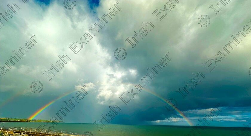 IMG-0534 
 Looking out over Garryveo beach when a very heavy shower passed over and then a amazing rainbow appeared 
Called: looking for the pot of gold