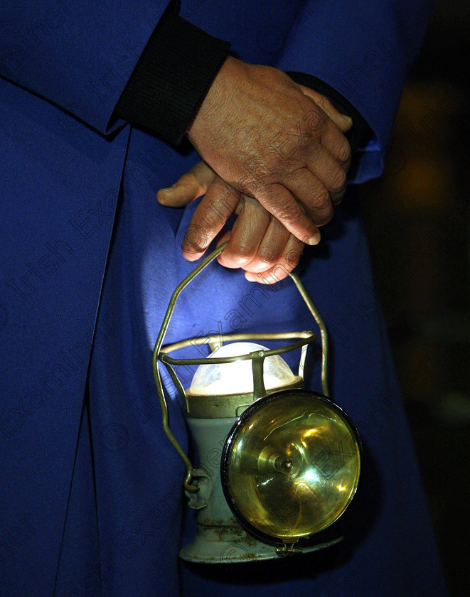 ULSTER Titanic Requiem 08162 
 Dean John Mann holds a lantern during a Requiem service at St Anne's Church of Ireland Cathedral in Belfast, on the anniversary of the sinking of the Titanic 100 years ago this weekend. PRESS ASSOCIATION Photo. Picture date: Saturday April 14, 2012. See PA story ULSTER Titanic Requiem. Photo credit should read: Paul Faith/PA Wire