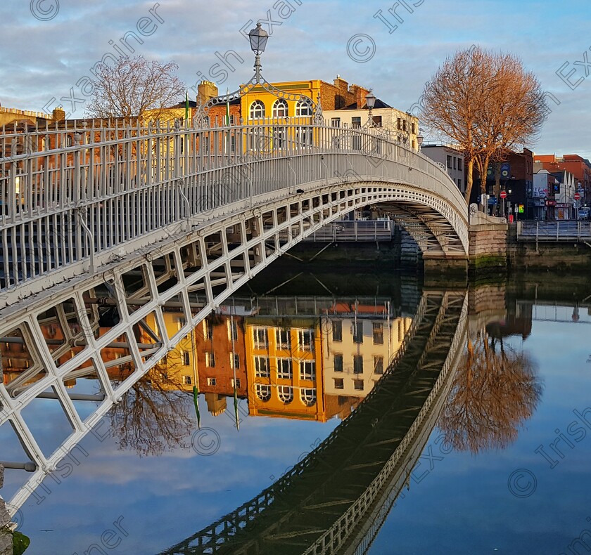 James Grandfield HaPenny Bridge 
 The HaPenny bridge reflecting beautifully on the calm waters of the Liffey