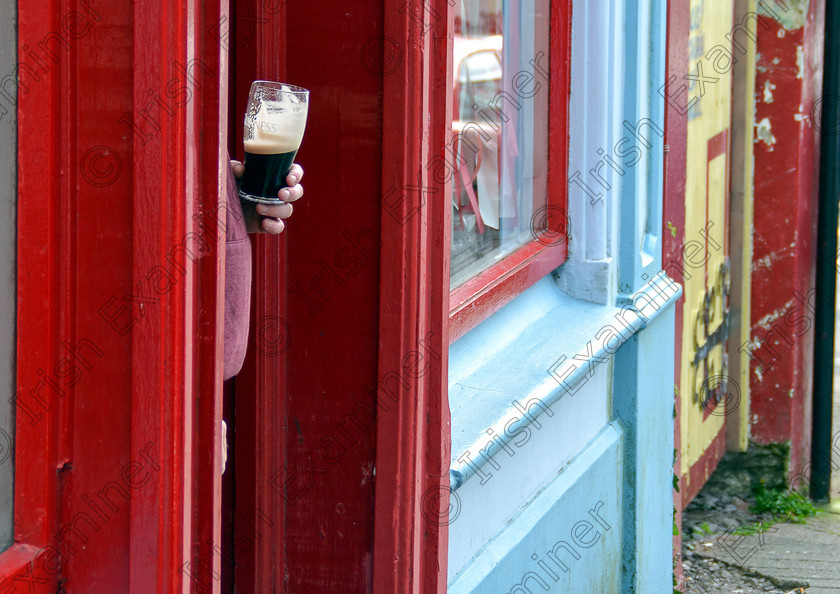 DSC 0048 
 Enjoying a pint at the door of Dick Mack's in Dingle, Co. Kerry. Picture: Cormac Costello.