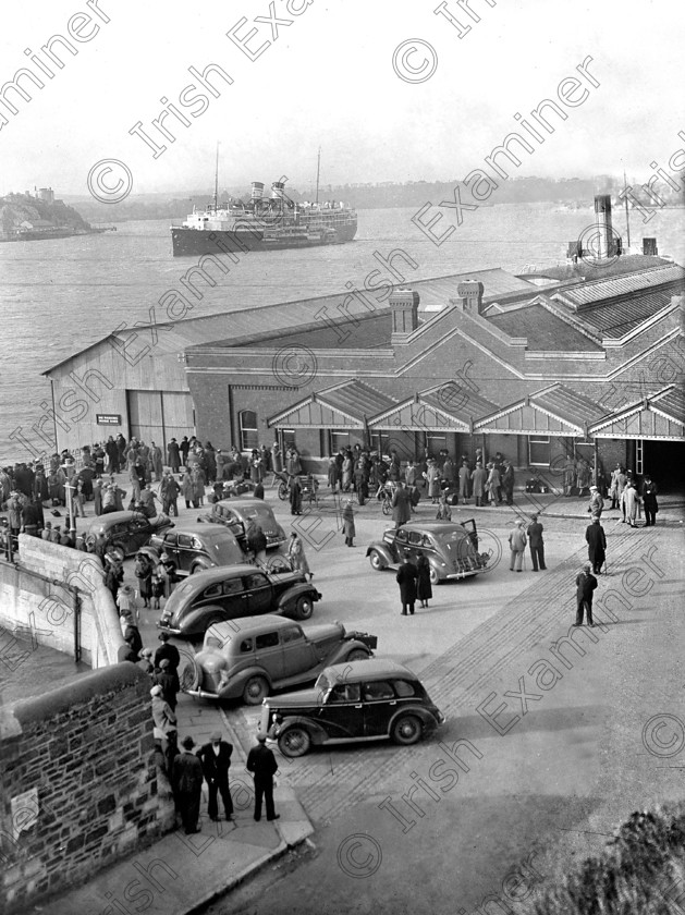 725948 725948 
 Please archive -
Pictured outside Cobh railway station are some of the hundreds of American tourists, stranded in Ireland upon the outbreak of the second world war, who embarked on the American liner s.s. Iroquois (seen in the background) which was specially chartered to bring them back to the U.S. 04/09/1939 Ref. 413C Old black and white ships