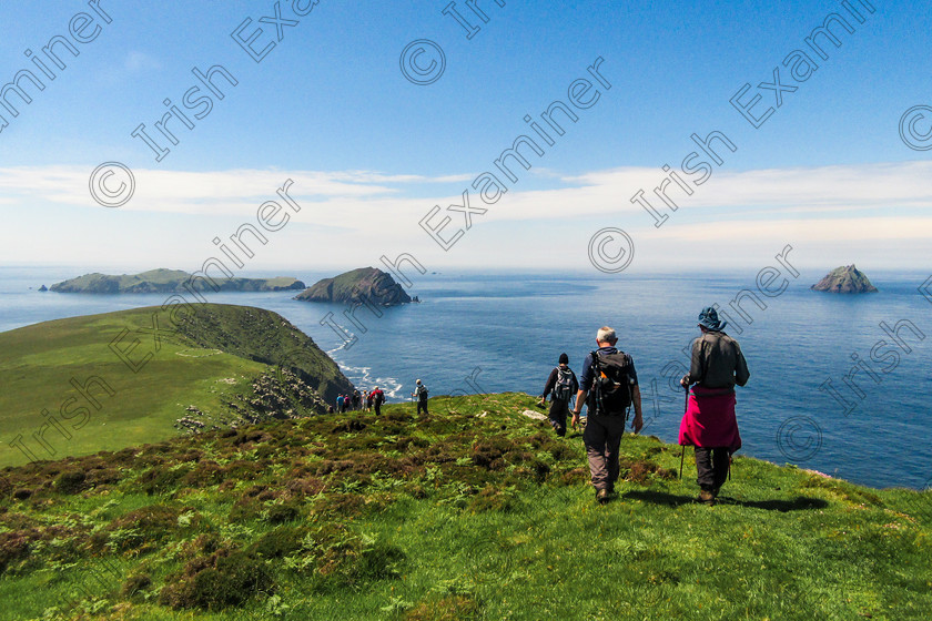 Blaskets 2018-0874 
 Hikers on the Great Blasket Island Dingle Co Kerry, looking out on (from left to right) Inisvickillaun,Inis na Bró agus An Tiaracht. Photo taken by Noel O Neill - June 2018 
 Keywords: Blaskets, DHC, Seascape