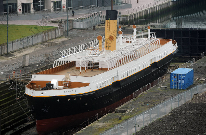 Titanic Belfast Preview 26 
 Alan Lewis - PhotopressBelfast.co.uk 14/3/2012
Mandatory Credit - Picture by Justin Kernoghan
The SS Nomadic - A steamship of the White Star Line, launched on 25 April 1911 in Belfast. She was built as a tender to the liners RMS Olympic and RMS Titanic, and is the last remaining vessel built for the White Star Line still afloat, which sits in a dry dock beside the new Titanic Belfast building in Belfast's Titanic Quarter.
Press Release
Opening in March 2012, Titanic Belfast® will be a "must see" visit in any tour of Belfast and Northern Ireland. It is located in the heart of Belfast, on the slipways where RMS Titanic was built.
Inside this iconic building, visitors will re-live the entire Titanic story from her birth in Belfast to the fateful maiden voyage and her eventual discovery on the seabed.
Titanic Belfast® extends over nine galleries, with multiple dimensions to the exhibition, drawing together special effects, dark rides, full-scale reconstructions and innovative interactive features to explore the Titanic story in a fresh and insightful way; from her conception in Belfast in the early 1900s, through her construction and launch, to her infamous maiden voyage and catastrophic demise. The journey goes beyond the aftermath of the sinking, to the discovery of the wreck and continues into the present day with a live undersea exploration centre. 
Further info contact Jonathan King - 028 90339949/07764 627 297
Embargoed until 17.00 Wednesday 14th March 2012 
 Keywords: Alan Lewis 00447850 988920, Justin Kernoghan 00447525 763088, Photopress Belfast