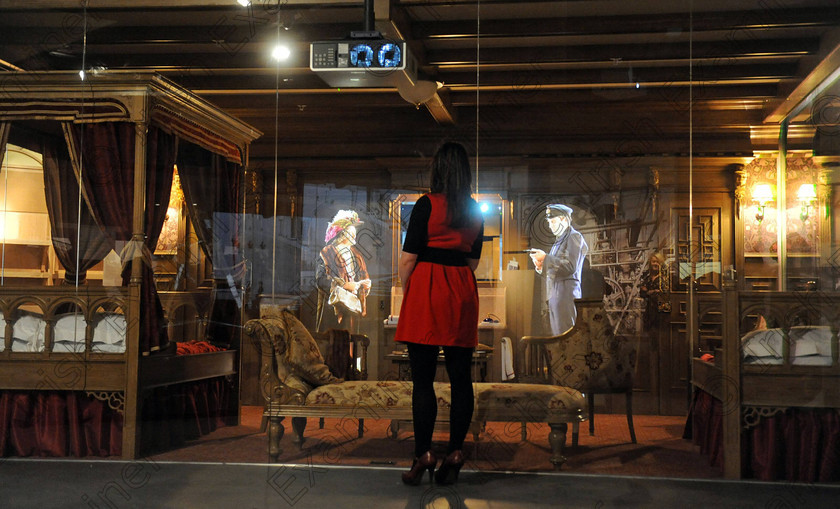 Titanic Belfast Preview 23 
 Alan Lewis - PhotopressBelfast.co.uk 14/3/2012
Mandatory Credit - Picture by Justin Kernoghan
A visitor admiring the fine joinery and upholstery in a replica First Class cabin on the Titanic (which also has a 3D projection of a passenger and a crew member), in Gallery Four (The Fit-out) at the new Titanic Belfast building in Belfast's Titanic Quarter.
Press Release
Opening in March 2012, Titanic Belfast® will be a "must see" visit in any tour of Belfast and Northern Ireland. It is located in the heart of Belfast, on the slipways where RMS Titanic was built.
Inside this iconic building, visitors will re-live the entire Titanic story from her birth in Belfast to the fateful maiden voyage and her eventual discovery on the seabed.
Titanic Belfast® extends over nine galleries, with multiple dimensions to the exhibition, drawing together special effects, dark rides, full-scale reconstructions and innovative interactive features to explore the Titanic story in a fresh and insightful way; from her conception in Belfast in the early 1900s, through her construction and launch, to her infamous maiden voyage and catastrophic demise. The journey goes beyond the aftermath of the sinking, to the discovery of the wreck and continues into the present day with a live undersea exploration centre. 
Further info contact Jonathan King - 028 90339949/07764 627 297
Embargoed until 17.00 Wednesday 14th March 2012 
 Keywords: Alan Lewis 00447850 988920, Justin Kernoghan 00447525 763088, Photopress Belfast