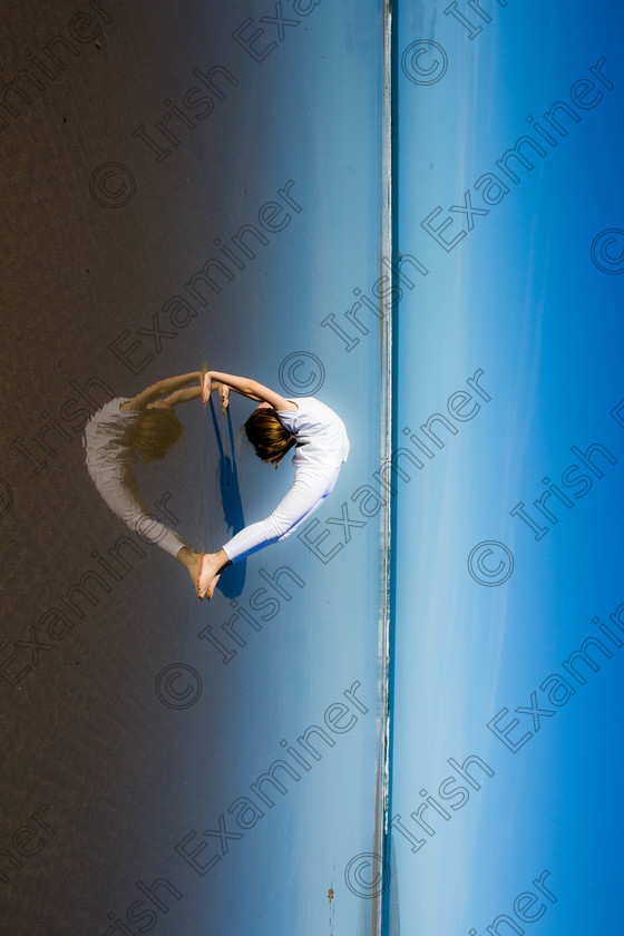 i heart banna sideways 
 Maggie Tobin practising her gymnastics on Banna Strand Co Kerry . The reflection makes the bridge pose look like her heart thus reflecting our love of this beach #iheartbanna