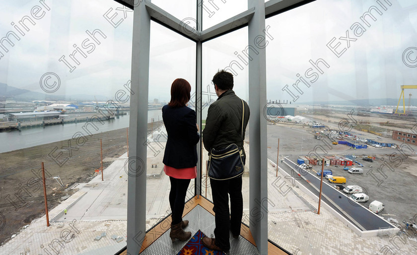 Titanic Belfast Preview 25 
 Alan Lewis - PhotopressBelfast.co.uk 14/3/2012
Mandatory Credit - Picture by Justin Kernoghan
Visitors looking out over Harland & Wolff shipyard (the concrete strip to the left is the dry dock where Titanic was built) at the new Titanic Belfast building in Belfast's Titanic Quarter.
Press Release
Opening in March 2012, Titanic Belfast® will be a "must see" visit in any tour of Belfast and Northern Ireland. It is located in the heart of Belfast, on the slipways where RMS Titanic was built.
Inside this iconic building, visitors will re-live the entire Titanic story from her birth in Belfast to the fateful maiden voyage and her eventual discovery on the seabed.
Titanic Belfast® extends over nine galleries, with multiple dimensions to the exhibition, drawing together special effects, dark rides, full-scale reconstructions and innovative interactive features to explore the Titanic story in a fresh and insightful way; from her conception in Belfast in the early 1900s, through her construction and launch, to her infamous maiden voyage and catastrophic demise. The journey goes beyond the aftermath of the sinking, to the discovery of the wreck and continues into the present day with a live undersea exploration centre. 
Further info contact Jonathan King - 028 90339949/07764 627 297
Embargoed until 17.00 Wednesday 14th March 2012 
 Keywords: Alan Lewis 00447850 988920, Justin Kernoghan 00447525 763088, Photopress Belfast