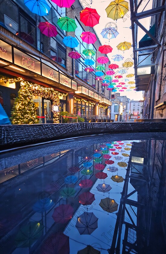 James Grandfield Annes Lane 
 Got me covered. Some colourful umbrella reflections in Anne's Lane, Dublin.