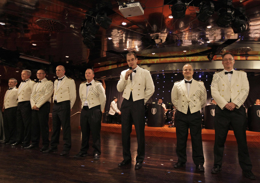 BRITAIN Titanic 40 
 Robert Bamberg, center, the captain of the MS Balmoral Titanic memorial cruise ship, introduces his officers during a reception in the Atlantic Ocean, Friday, April 13, 2012. Nearly 100 years after the Titanic went down, the cruise with the same number of passengers aboard is setting sail to retrace the ship's voyage, including a visit to the location where it sank. The Titanic Memorial Cruise departed Sunday, April 8, from Southampton, England, where the Titanic left on its maiden voyage and the 12-night cruise will commemorate the 100th anniversary of the sinking of the White Star liner early Sunday, April 15, 2012. (AP Photo/Lefteris Pitarakis)