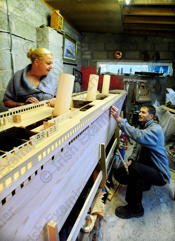 1377005 
 NEWS 19/01/2012 Zoltan Panka working on his 16ft model of the Titanic in the garden shed, with Carmel McGrath. 
Picture Denis Scannell 
 Keywords: DENIS SCANNELL