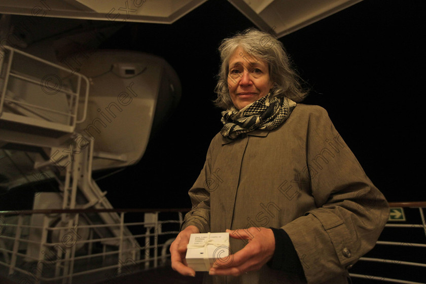 SEA Titanic 14 
 Helen Edwards, 62, from Silver Spring, Maryland holds a box with ashes of family friend Adam Lackey, a Titanic buff from Montana who died last year as the MS Balmoral Titanic memorial cruise ship reaches the wreck site of the Titanic in the Atlantic Ocean, late Saturday, April 14, 2012. Edwards hold her own private act of remembrance. She scattered the ashes at the wreck site, as per family wishes. (AP Photo/Lefteris Pitarakis)