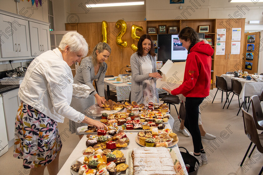 dan-re-6 
 Teacher Gobnait Uí Laoire getting a helping hand putting out the cakes at the 125-year anniversary celebration of the opening of Réidh na nDoirí National School, Renanirreem Co Cork. Picture Dan Linehan