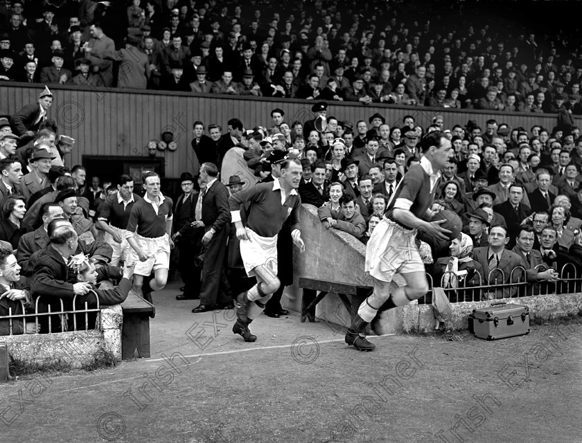 320488 
 Cork Athletic captain Florrie Burke, followed by Paddy O'Leary and Willie Cotter (?) leads his team out against Dundalk in the 1952 F.A.I. Cup Final at Dalymount Park, Dublin. This was the team's third year in a row to reach the final. Ref. 446E.