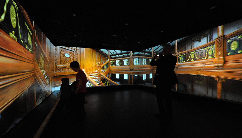 Titanic Belfast Preview 9 0 
 Alan Lewis - PhotopressBelfast.co.uk 27/3/2012
Mandatory Credit - Picture by Justin Kernoghan
Visitors enjoying the 3D cube which allows you to take a tour of the inside of the Titanic in 3D at the Titanic Belfast building today. 
Opening in March 2012, Titanic Belfast® will be a "must see" visit in any tour of Belfast and Northern Ireland. It is located in the heart of Belfast, on the slipways where RMS Titanic was built.
Inside this iconic building, visitors will re-live the entire Titanic story from her birth in Belfast to the fateful maiden voyage and her eventual discovery on the seabed.
Titanic Belfast® extends over nine galleries, with multiple dimensions to the exhibition, drawing together special effects, dark rides, full-scale reconstructions and innovative interactive features to explore the Titanic story in a fresh and insightful way; from her conception in Belfast in the early 1900s, through her construction and launch, to her infamous maiden voyage and catastrophic demise. The journey goes beyond the aftermath of the sinking, to the discovery of the wreck and continues into the present day with a live undersea exploration centre. 
Further info contact Jonathan King - 028 90339949/07764 627 297 
 Keywords: Alan Lewis 00447850 988920, Justin Kernoghan 00447525 763088, Photopress Belfast