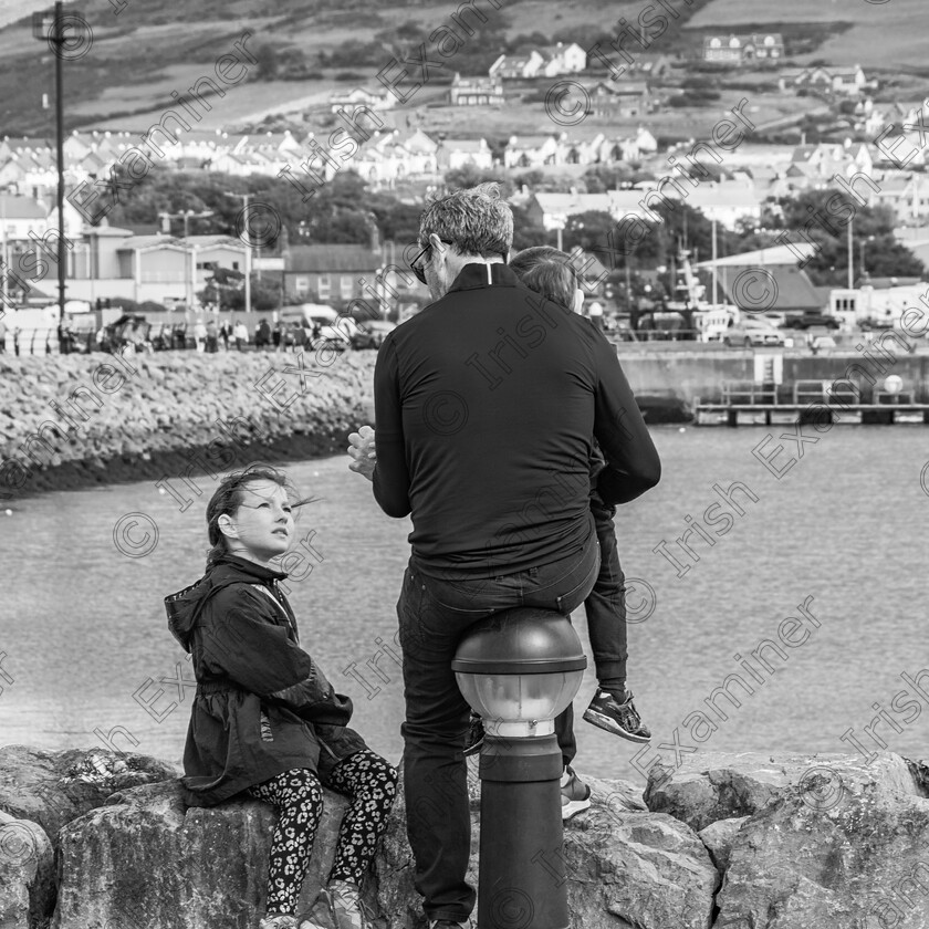 Family affair-1114 
 Father and daughter in deep discussion at the All Ireland Coastal Rowing championships in Dingle recently. Photo taken Sept 2023 by: Noel O Neill 
 Keywords: Dingle, ICRC, Marina, Rowing, candid, street