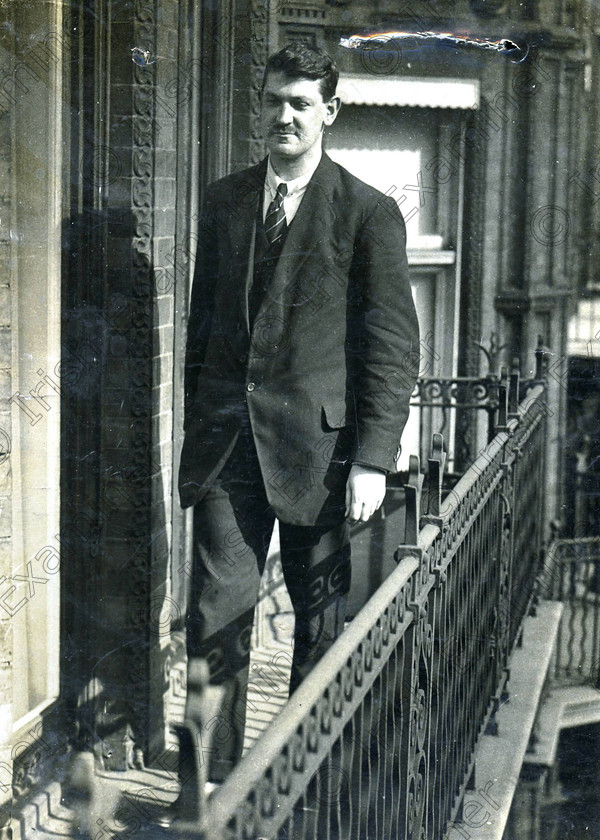 1402994 
 Echo News
A mounted photograph showing Michael Collins standing on an ironwork balcony, said
to be at No. 10 Downing Street, England, 1921. It is expected to attract at least €1,500.