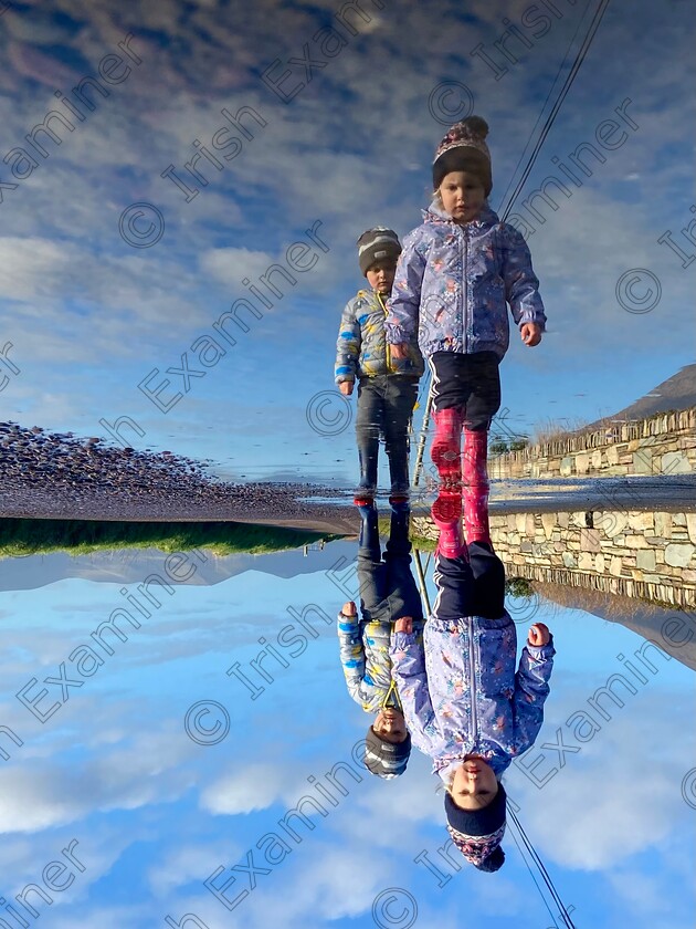 Reflection 
 First cousins Hannah Sugrue (2) & Jamie Sugrue (3) from Cahersiveen, Co. Kerry having a reflective stroll in the January sunshine.